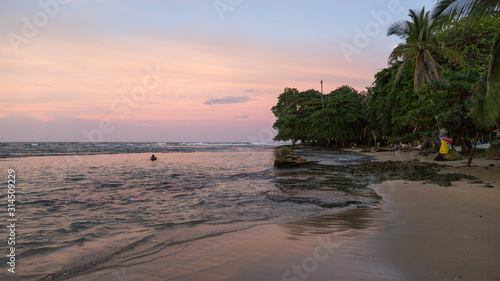 Sunset on the black sand beach of Puerto Viejo, Costa Rica © serge
