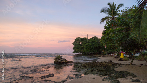 Sunset on the black sand beach of Puerto Viejo, Costa Rica