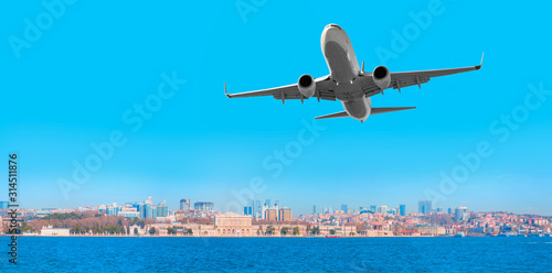 Photography Airplane flying over a city and the sea