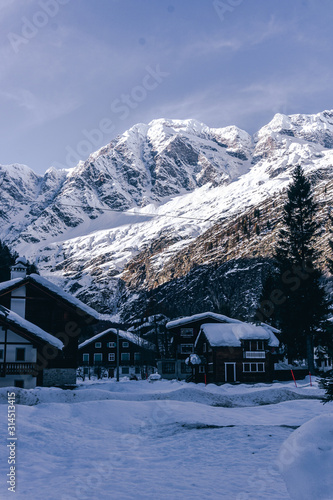 The town of Macugnaga, in the Italian Alps, with its typical houses, the snow and Monte Rosa - December 2019. © Roberto