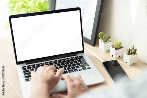 mockup image blank screen computer with white background for advertising text,hand man using laptop contact business search information on desk at coffee shop.marketing and creative design