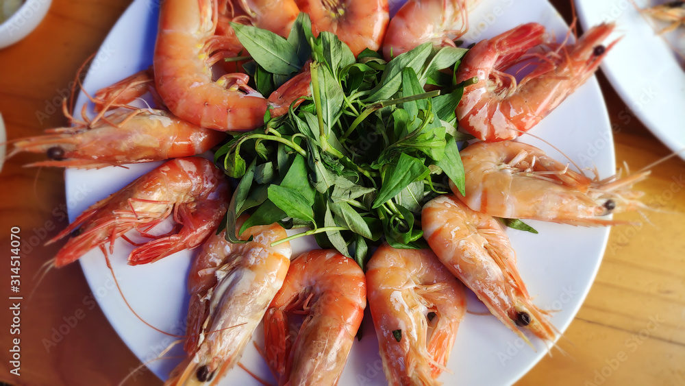 Big red shrimps Delicious king prawn boiled with head and sweet chillies sauce green vegetable herbs on white plate Asian cuisine Thai traditional food healthy fresh seafood Big red shrimps Delicious king prawn boiled with head and sweet chillies sauce green vegetable herbs on white plate Asian cuisine Thai traditional food healthy fresh seafood