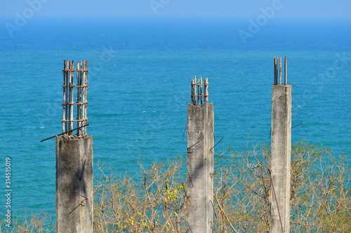 Concrete pillars in the sea. Construction on the ocean. © Victoria