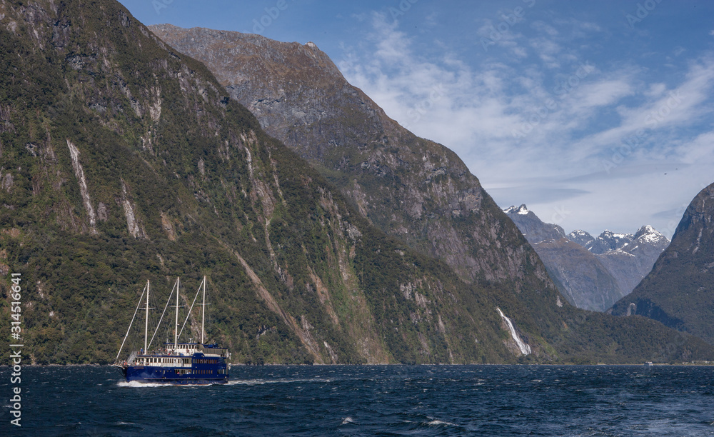 Milford Sound Fjordland New Zealand. South Island. Clouds. Mountains..Boat cruise.