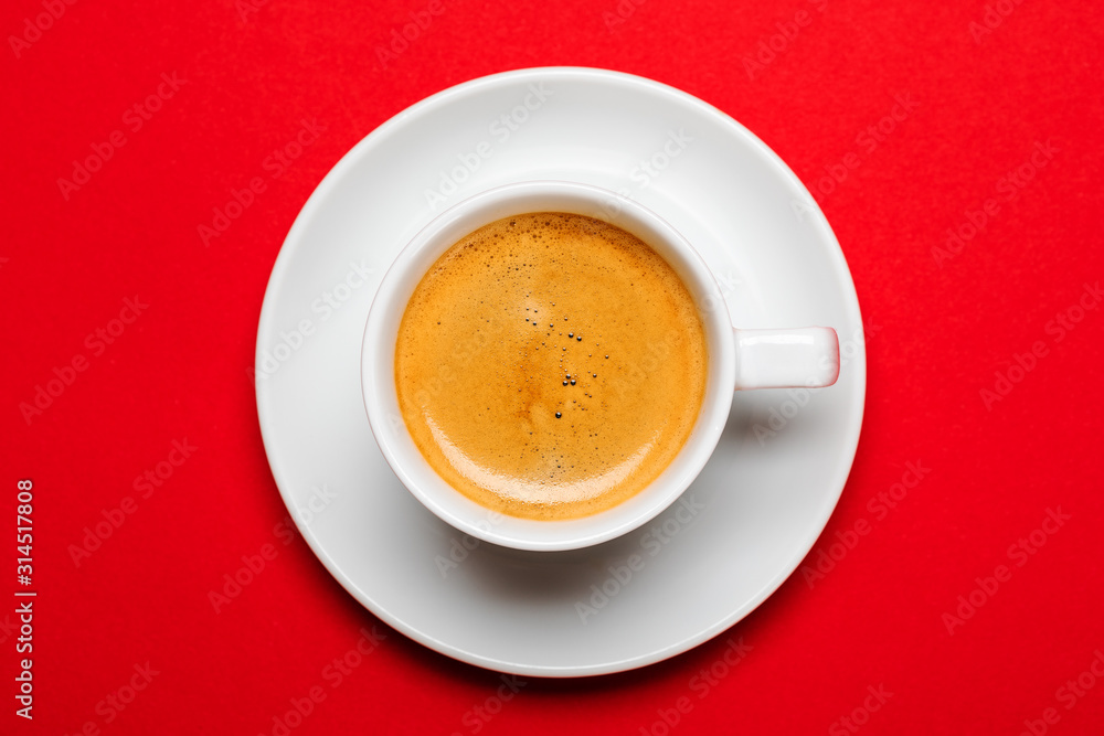 Black coffee in a cup on a red background Black coffee in a cup on a red background