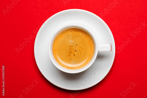 Black coffee in a cup on a red background