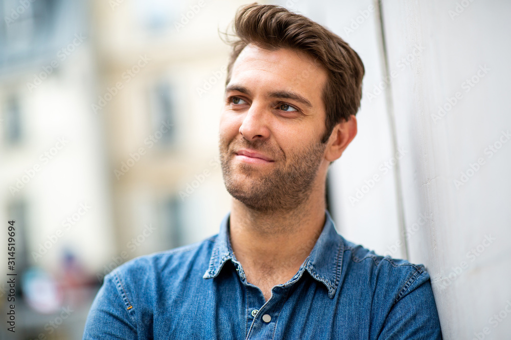 Close up older man leaning against wall and looking away Close up older man leaning against wall and looking away