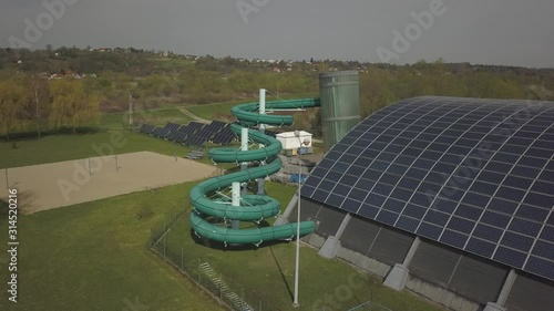 Jaslo, Poland - 9 3 2019: MOSiR municipal sports complex with an indoor pool with a water slide. The use of solar panels for ecologically clean electricity. Healthy lifestyle. Use of photovoltaics photo