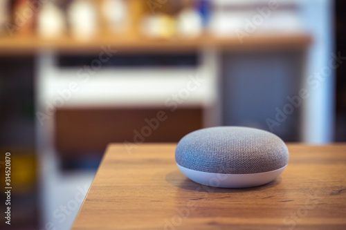 voice controlled smart speaker in a interior home environment. Smart home ai concept © David Ferencik