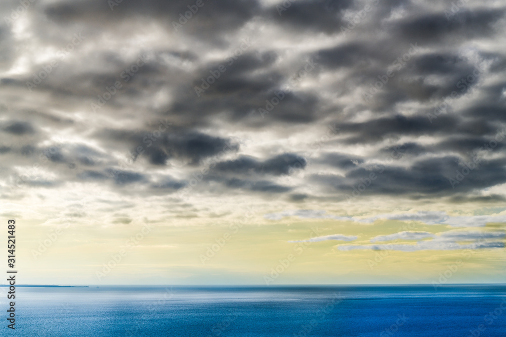 Beautiful serene overcast and tranquil sea and sky background. Neutral copy space for text