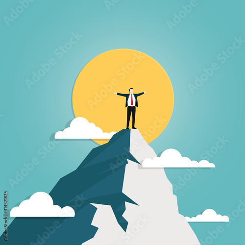 Businessman standing on top of mountain