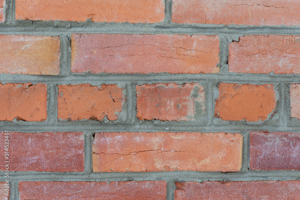 Obraz premium Weathered stained old red brick wall background. Close up