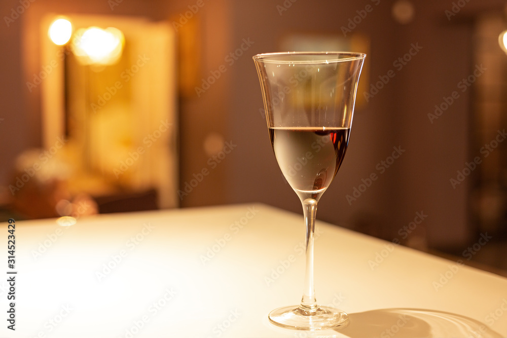Glass of red wine in a cozy interior Glass of red wine in a cozy interior