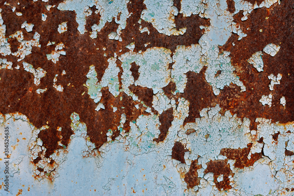 Multicolored background: rusty metal surface with blue paint flaking and cracking texture. Old metal background. Multicolored background: rusty metal surface with blue paint flaking and cracking texture. Old metal background.