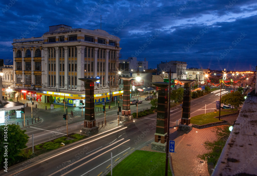 Invercargill Centre South Island. New Zealand. Mainstreet and crossroad with traffic at twilight. Night life.