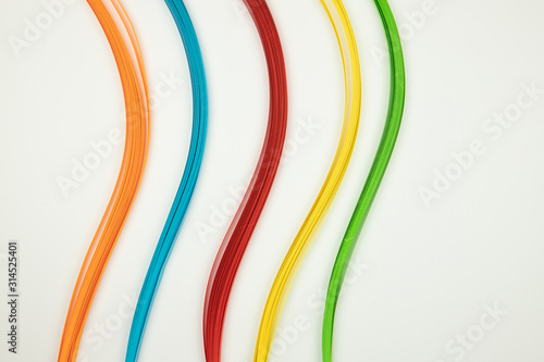 Orange, blue, red, yellow, green strips of paper on a white background. Abstract stock image. photo