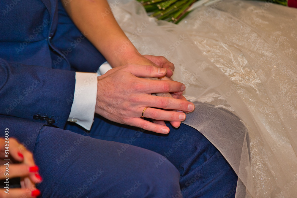 man and woman hands during a wedding