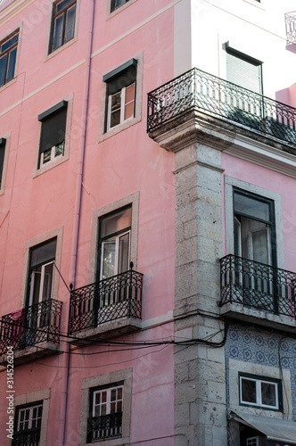 Traditional Portuguese apartments, painted pink, taken on a sunny summer day in Lisbon.