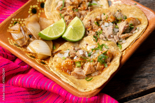 Mexican beef tacos also called "suadero" on wooden background