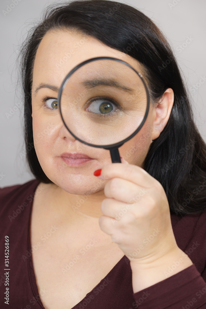 Adult woman with magnifying glass Adult woman with magnifying glass