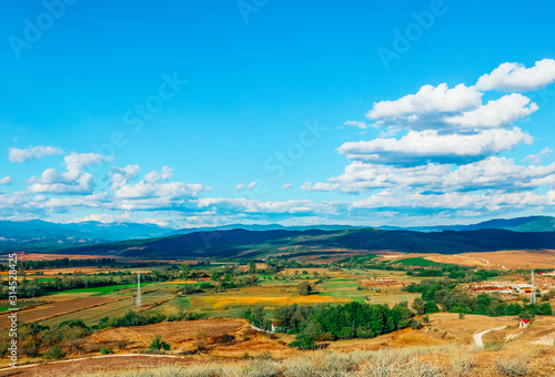 Fields and mountains of Provence, France. Electric towers, agriculture, farming.