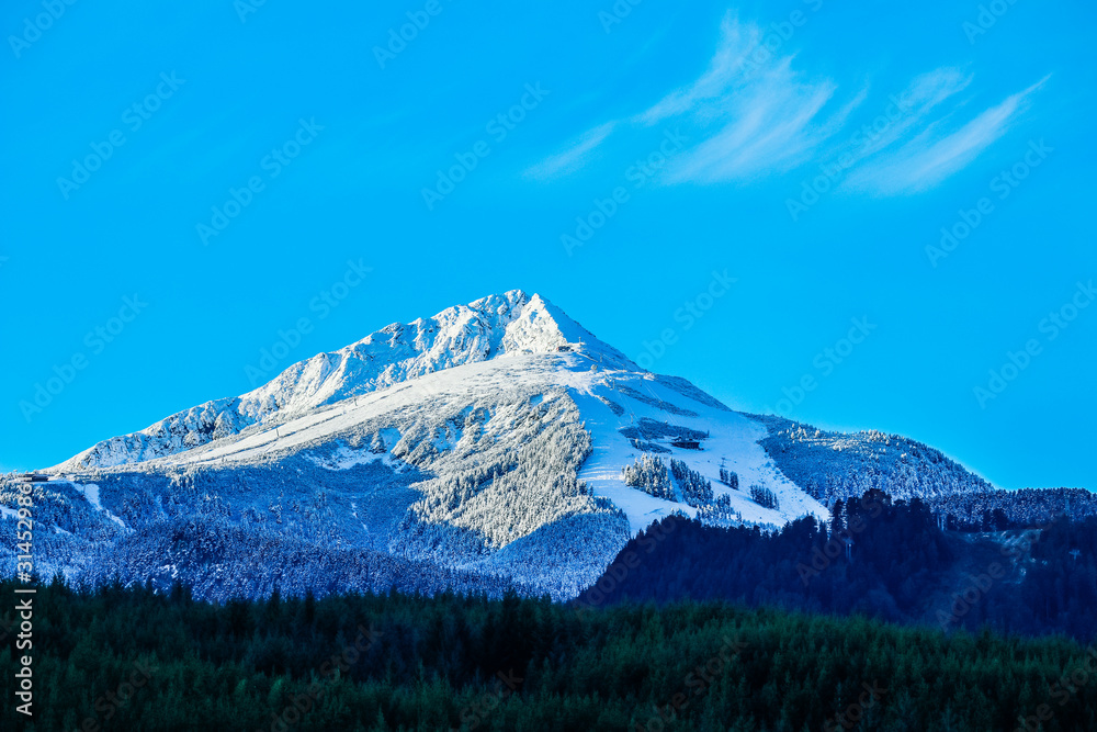 Balkans, Todorka mountain peak, ski tracks, covered with snow. Beautiful alpine natural winter backdrop. Pirin ice top of the hill on the blue sky background.