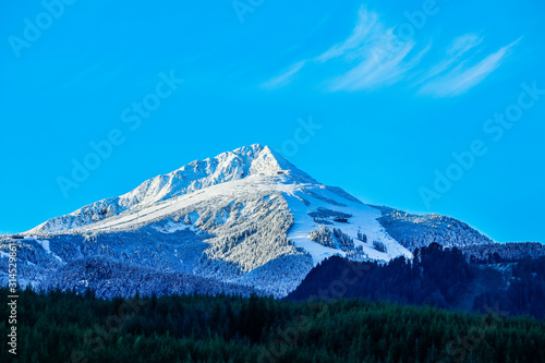 Balkans, Todorka mountain peak, ski tracks, covered with snow. Beautiful alpine natural winter backdrop. Pirin ice top of the hill on the blue sky background.