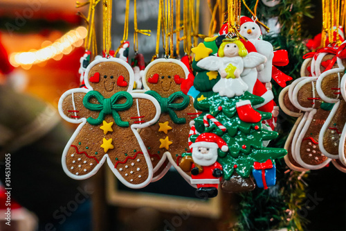 Ginger bread man and handmade Christmas toys on the street market, backdrop. Colorful New Year fair decor sale background.