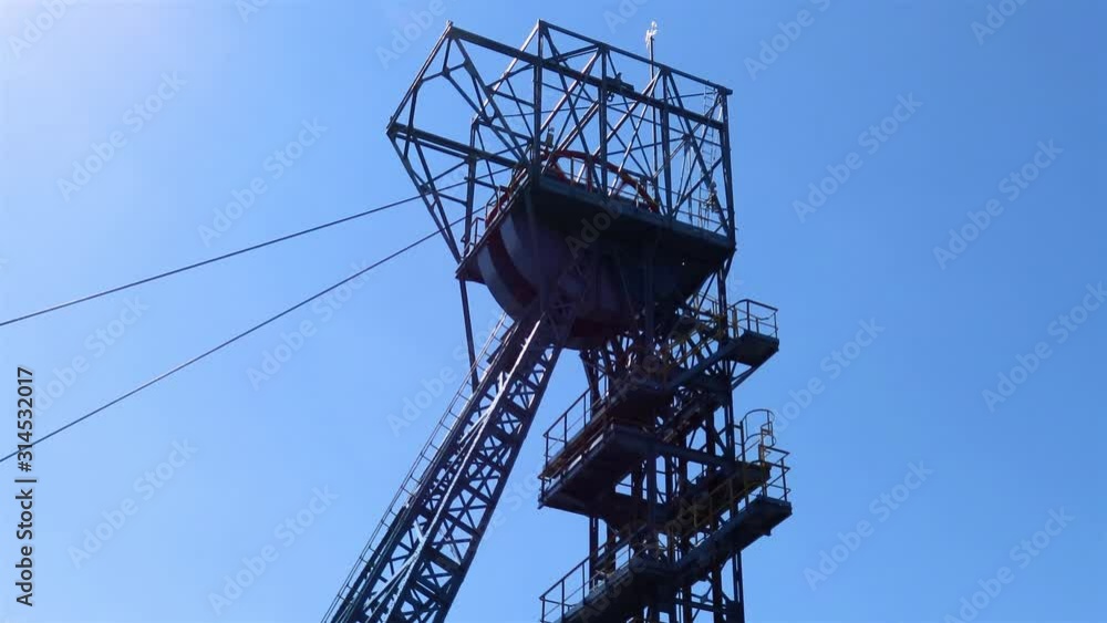 Rotating headgear of very old black coal mine Guido in Zabrze, Poland which is tourist attraction in recent years. The mine was built in 1855. Rotating headgear of very old black coal mine Guido in Zabrze, Poland which is tourist attraction in recent years. The mine was built in 1855.