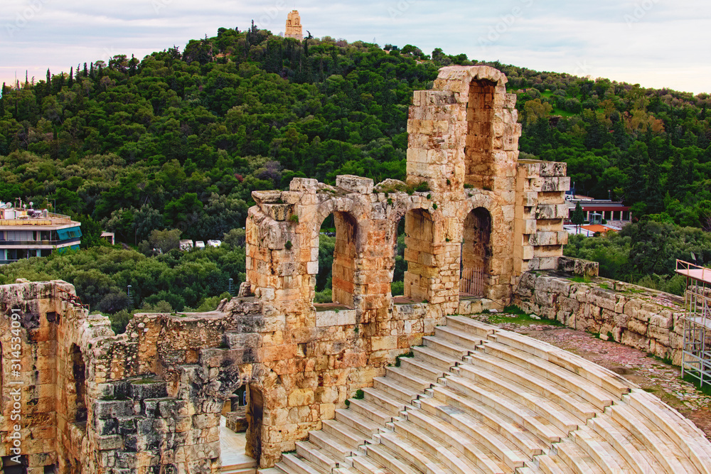 Scenic view of ancient ruins of the Odeon of Herodes Atticus. It is a small building of ancient Greece used for public performances of music and poetry, below on the Acropolis hill. Athens, Greece