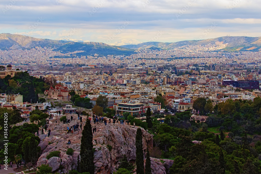 Picturesque panoramic view of Athens. Mountain range with snow in the background. Winter landscape. View from the Acropolis hill. Athens, Greece
