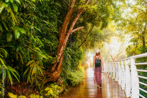Hainan, Sanya, Phoenix park. Girl in tropical forest.