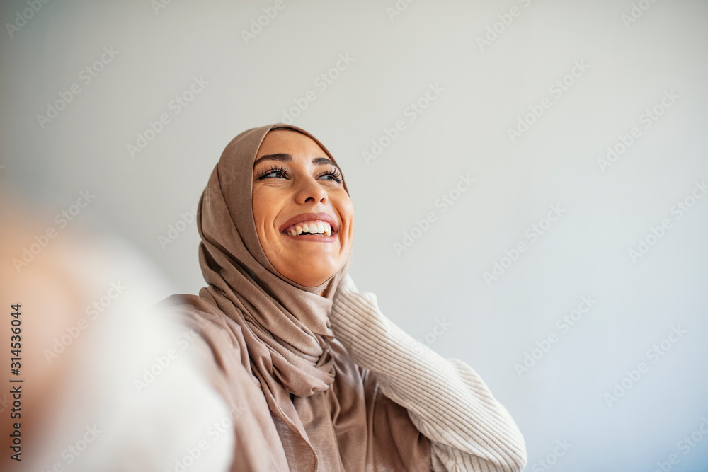 Premium Vector  Young muslim woman wearing hijab taking selfie