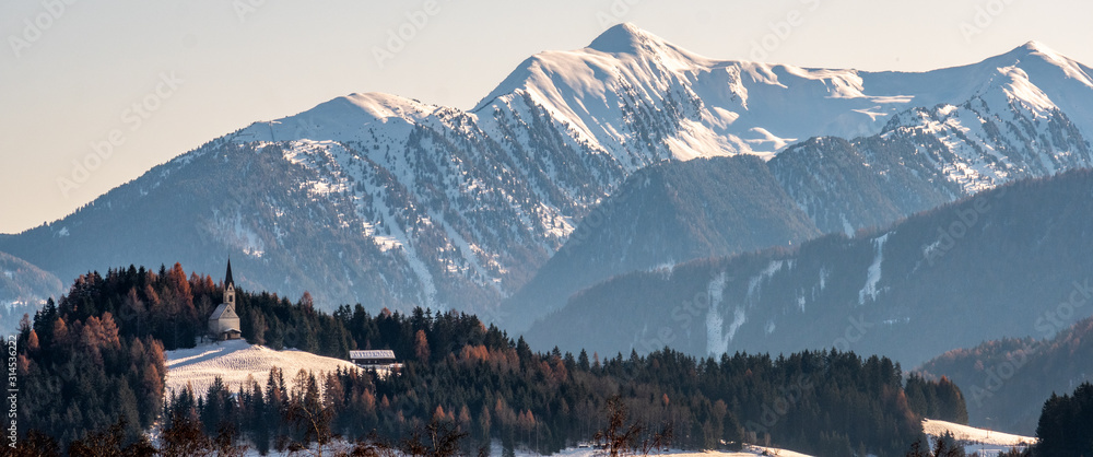 Mountain landscape, picturesque mountain church in the winter morning, large panorama
