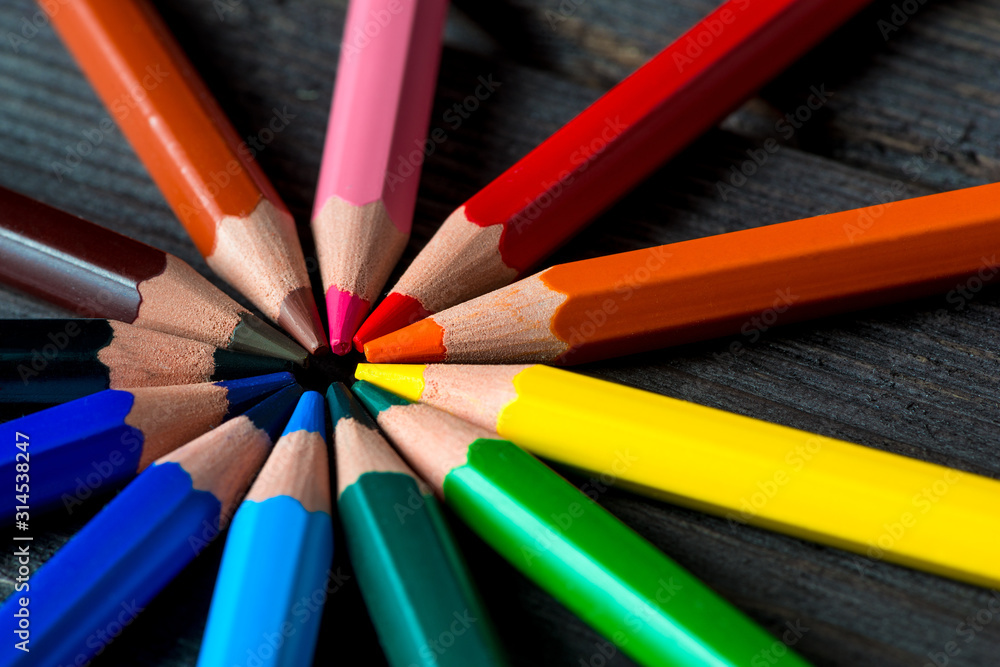 group of colored pencils arranged in a circle, close-up shot group of colored pencils arranged in a circle, close-up shot