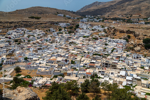View at the city of Lindos on Greek island Rhodes with white houses and mountain in the background © Reiner