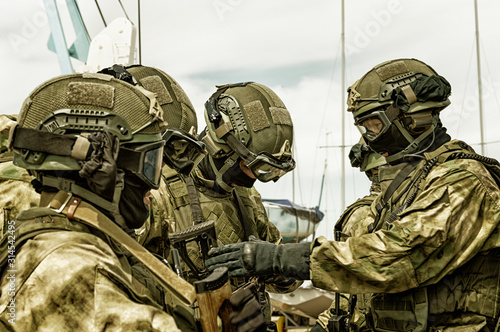 The commander of the swat group checks the ammunition of his fighters at a briefing. The concept of the war in Iraq, political problems. photo