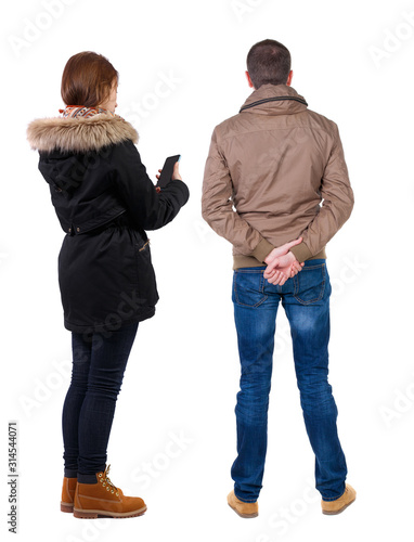 Back view of couple in winter jacket photographed on a mobile phone in winter jacket.