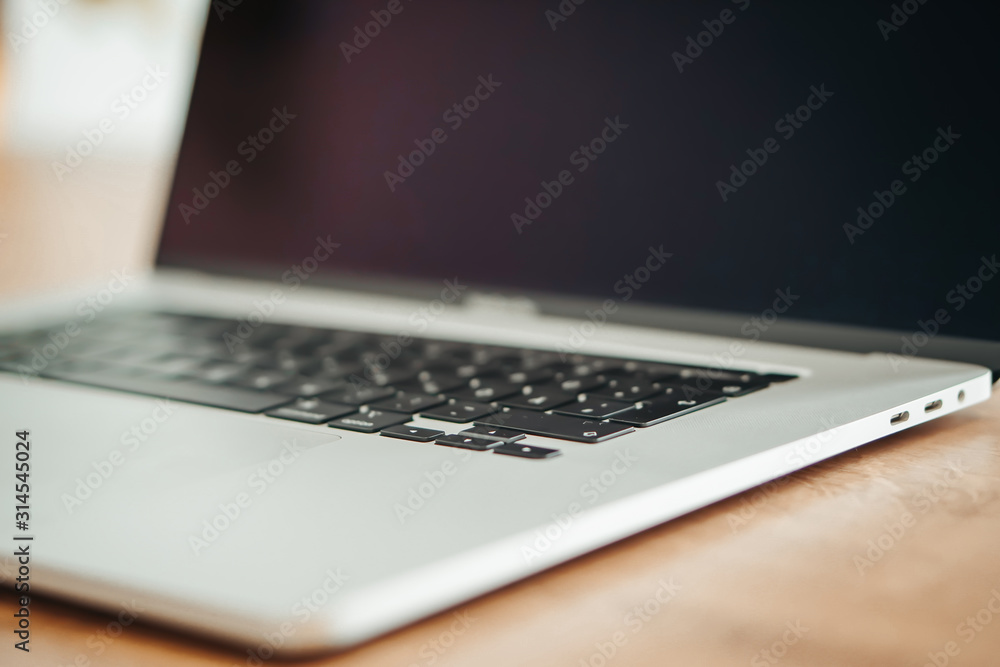 New Apple Macbook Pro on the wooden close up background.