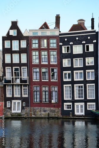 Traditional dutch medieval houses built right on a canal in Amsterdam, Netherlands