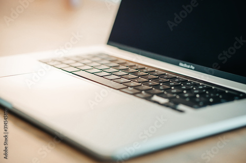 New Apple Macbook Pro on the wooden close up background.