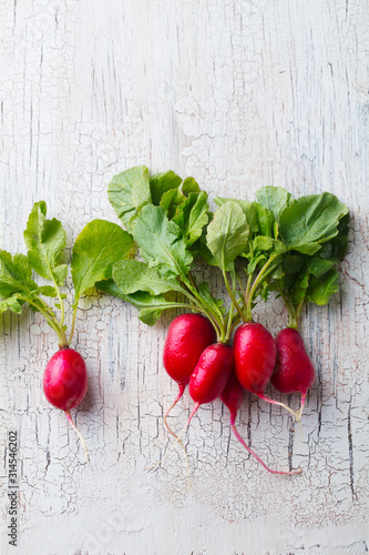 Radish on white wooden background. Copy space. Top view.