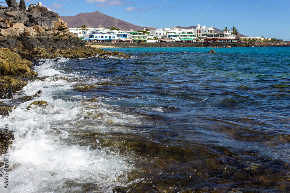 Lava rocks on the coastline of Playa Blanca at Canary island Lanzarote.
