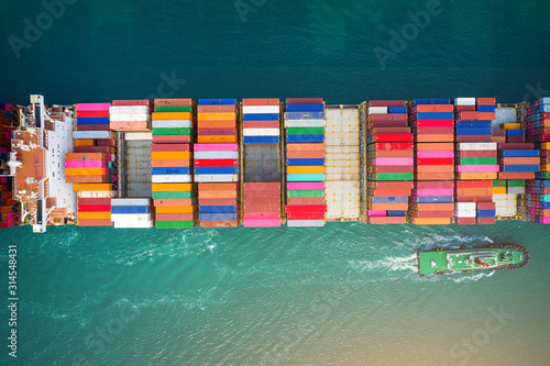 Container ship in export and import business and logistics. Aerial view.