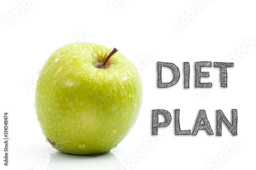 Diet Plan words written on isolated background with fresh green apple