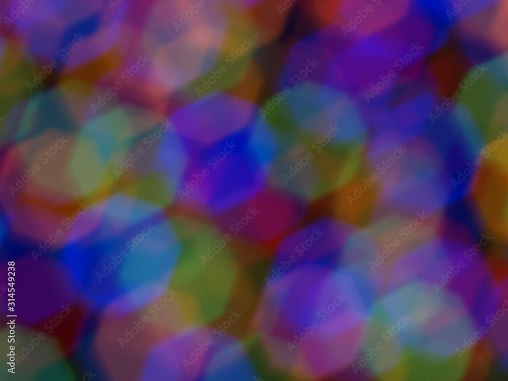 Abstract color pattern inside of kaleidoscope. Little pieces of light are mixed in one geometric ornament. Colorful vivid background. Seamless multicolored tile backdrop.