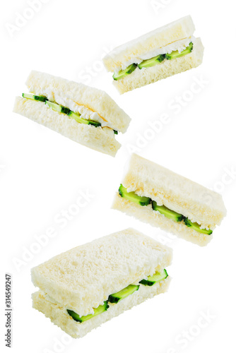 Cucumber cream cheese sandwiches on a white isolated background