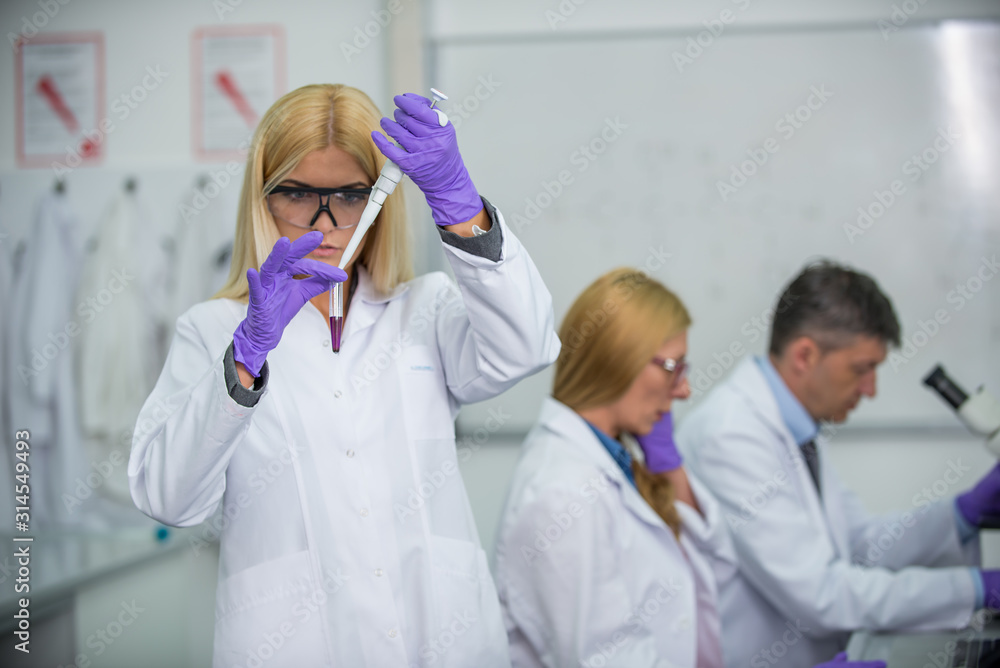 Laboratory scientists researching chemical compositions Laboratory scientists researching chemical compositions