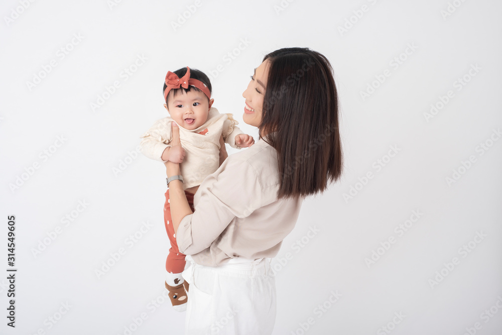 Asian mother and adorable baby girl are happy on white background Asian mother and adorable baby girl are happy on white background
