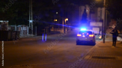 unfocused veiw on police car at night from side window of car. 